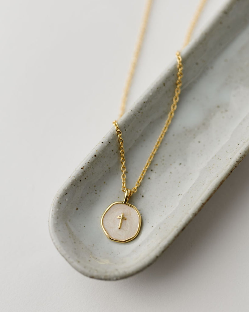 gold and ivory enamel disc pendant with gold cross on 16 in gold plated chain with 2 in extender