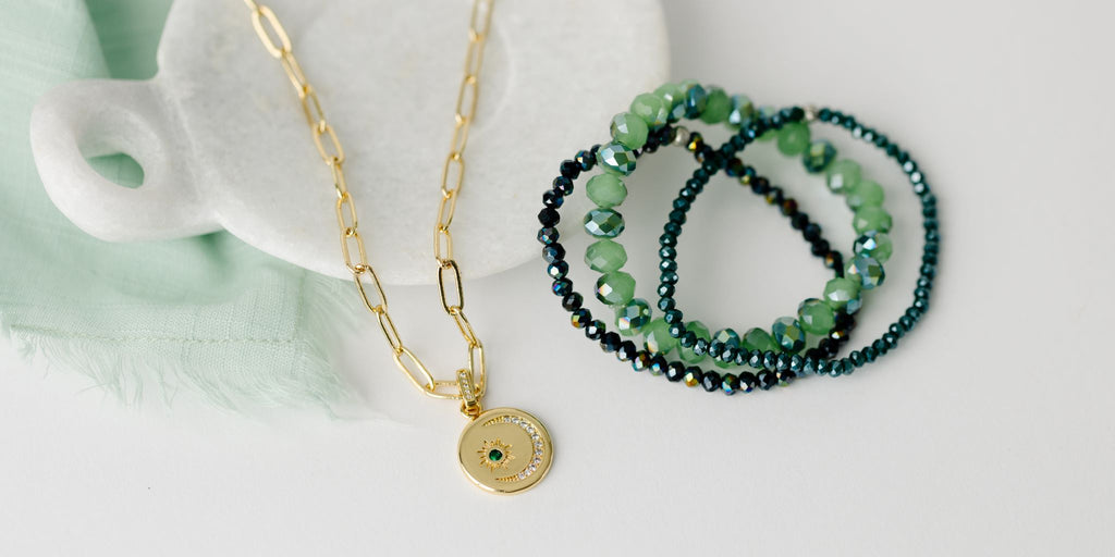 green stacker bracelet set with gold paperclip chain and moon star medallion