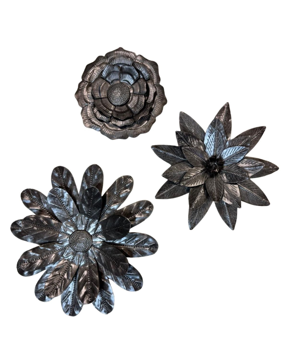 Three decorative metal flower wall art pieces on a white background