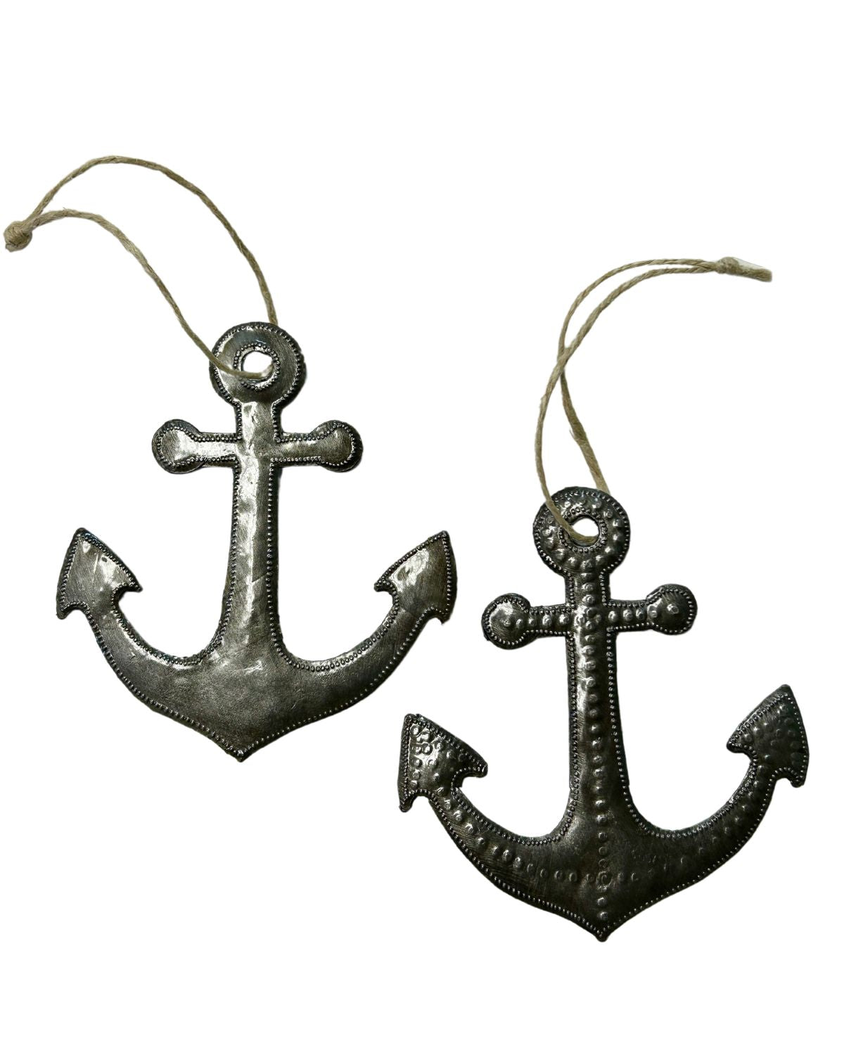 A set of two metal ornaments in the shape of anchors, with a nautical design, handmade in Haiti.