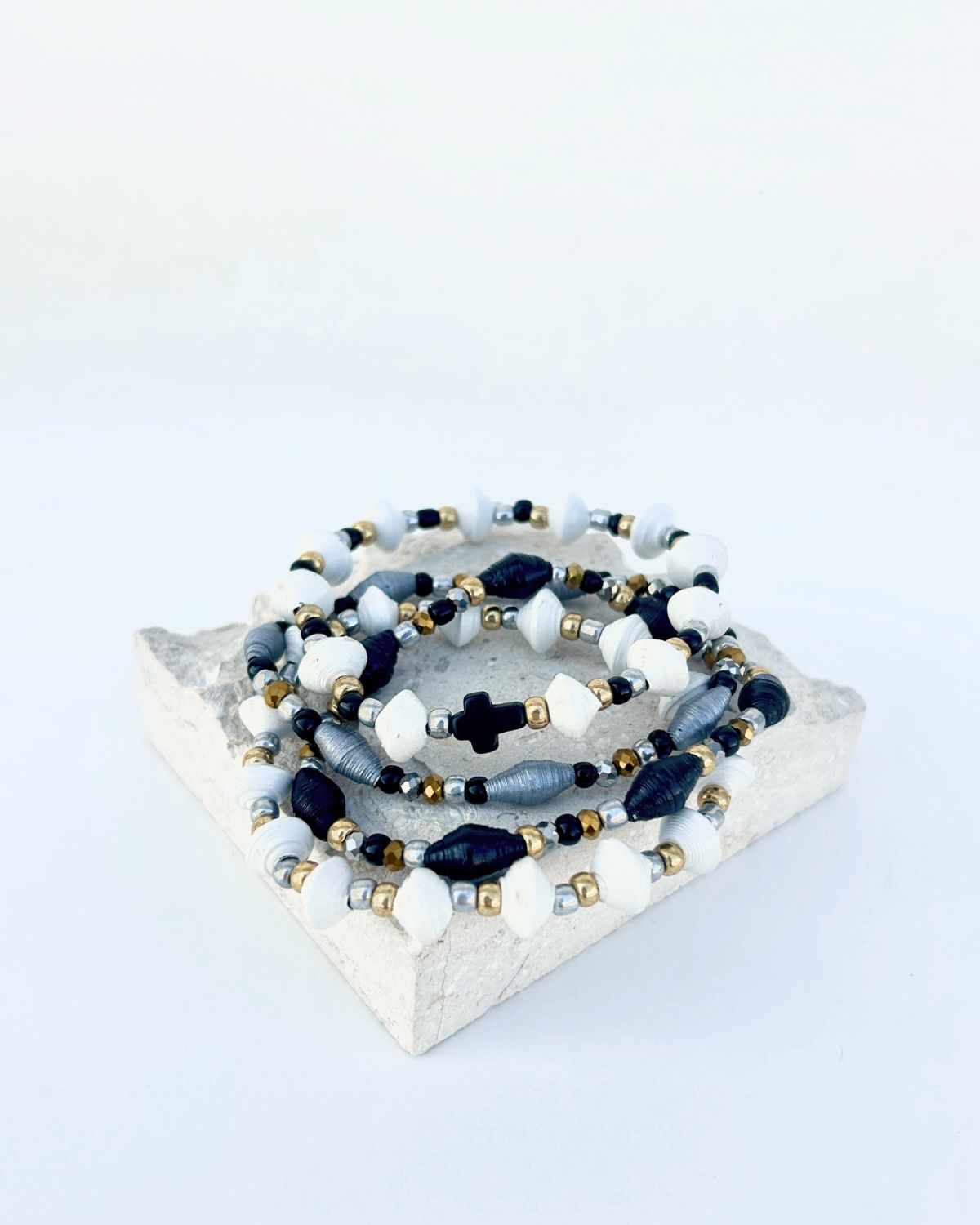 Set of beaded bracelets on a marble coaster with a white background