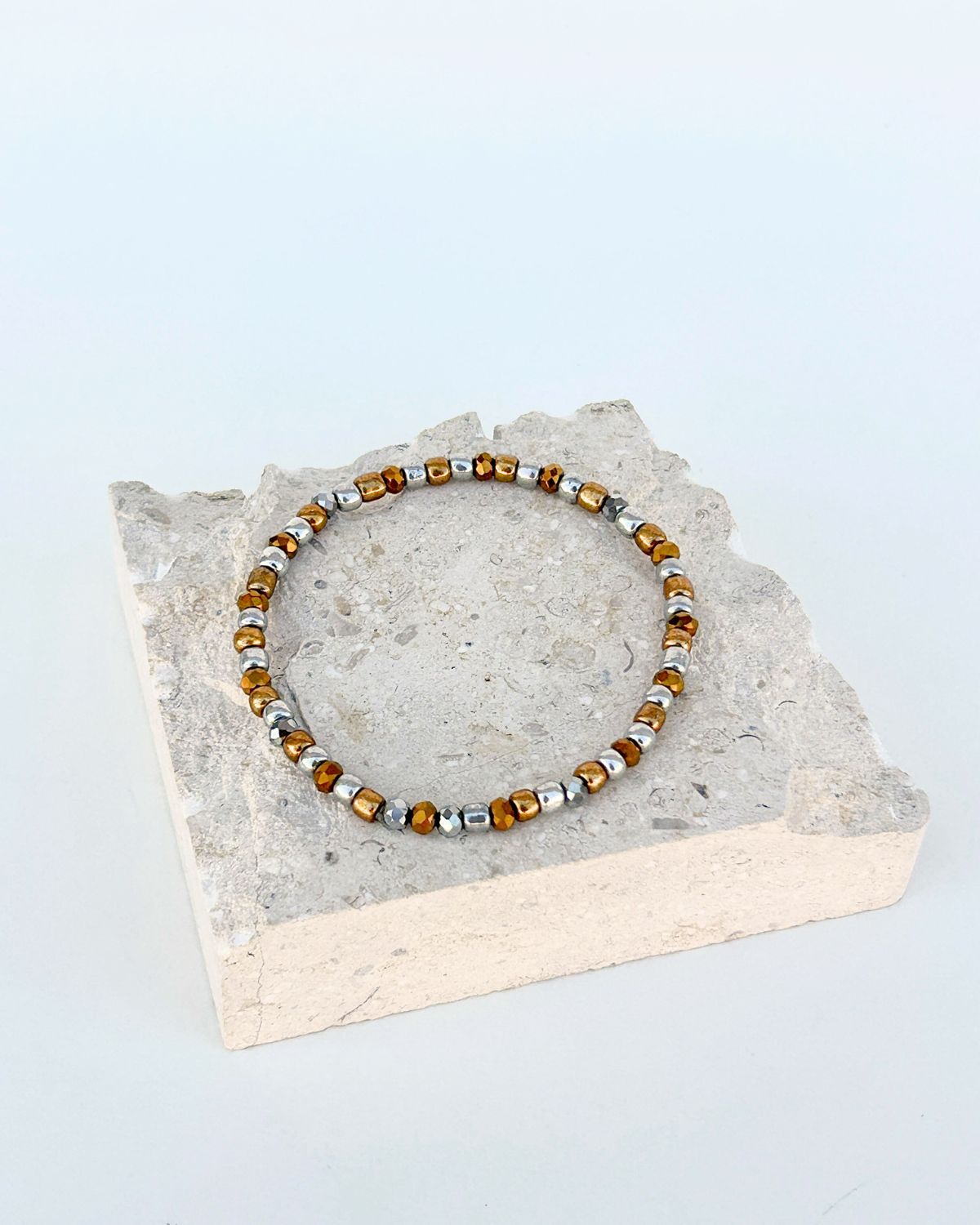 Beaded bracelet on a stone block with a light background