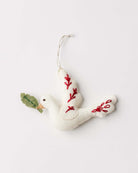 A handsewn and embroidered decoration, resembling a dove with leaf embroidery on its wings, primarily in a white color with red and gold details.