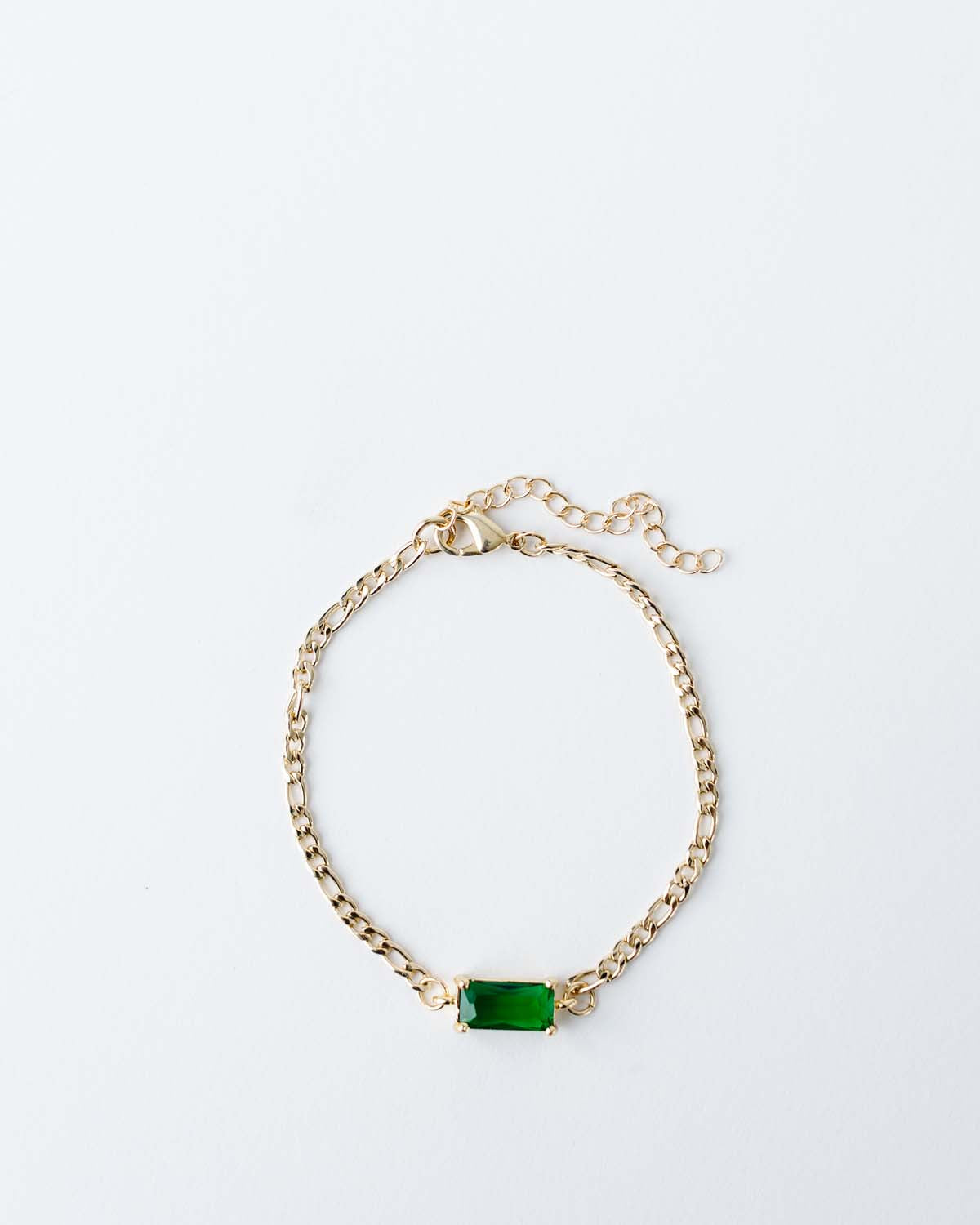 gold figaro chain bracelet 6.5" with 2" extender. Rectangle emerald green CZ connector.