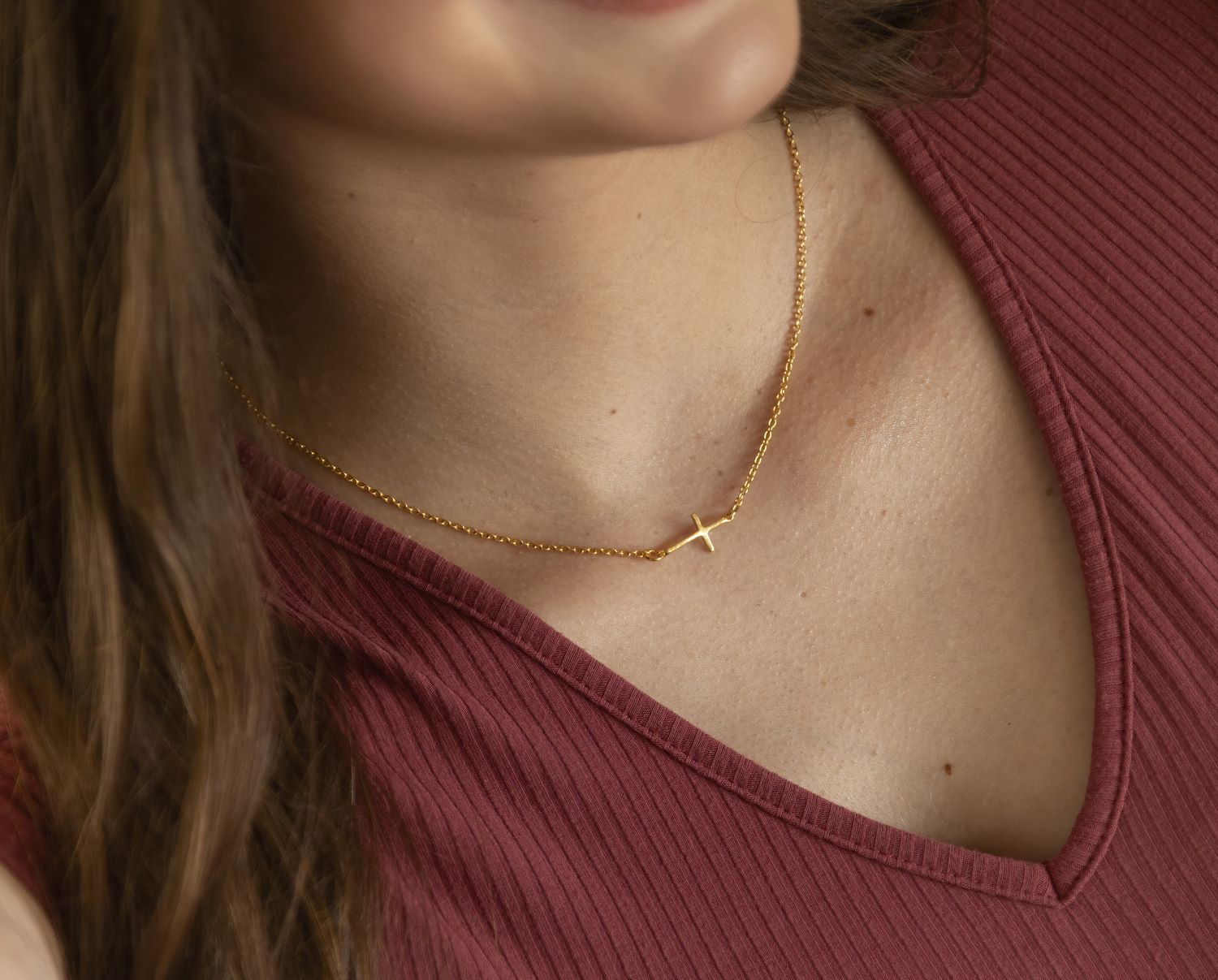 gold sideways cross pendant on gold chain