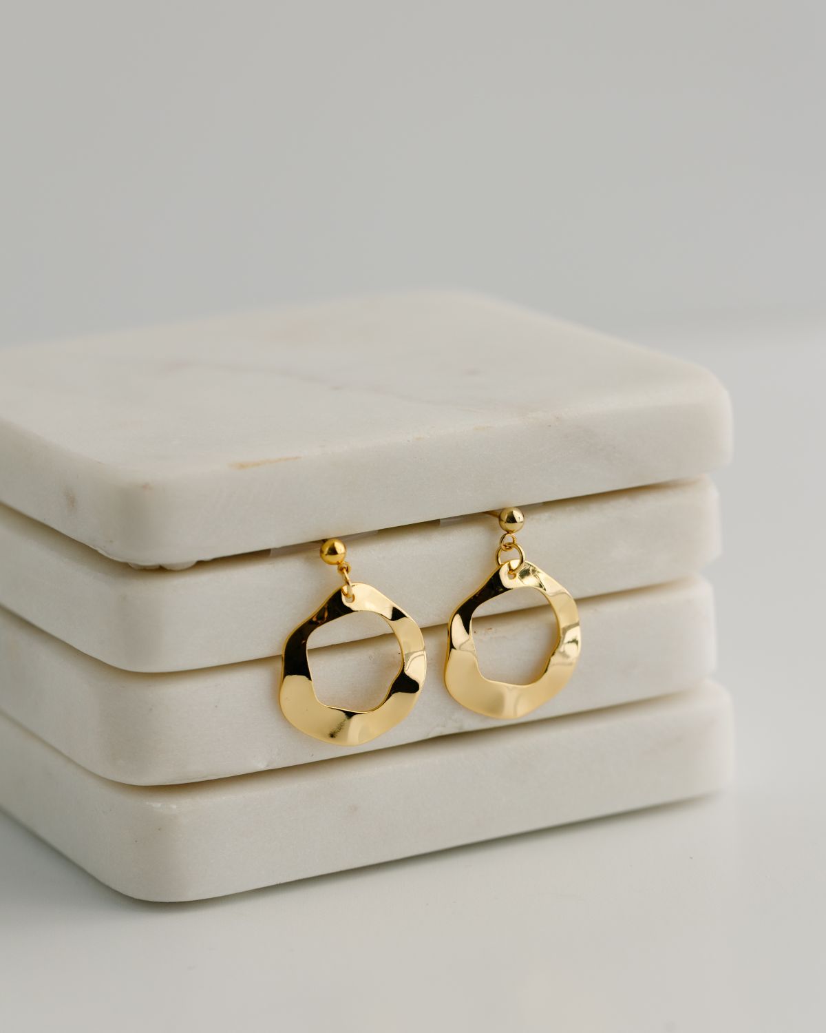 Gold hoop earrings on a stud