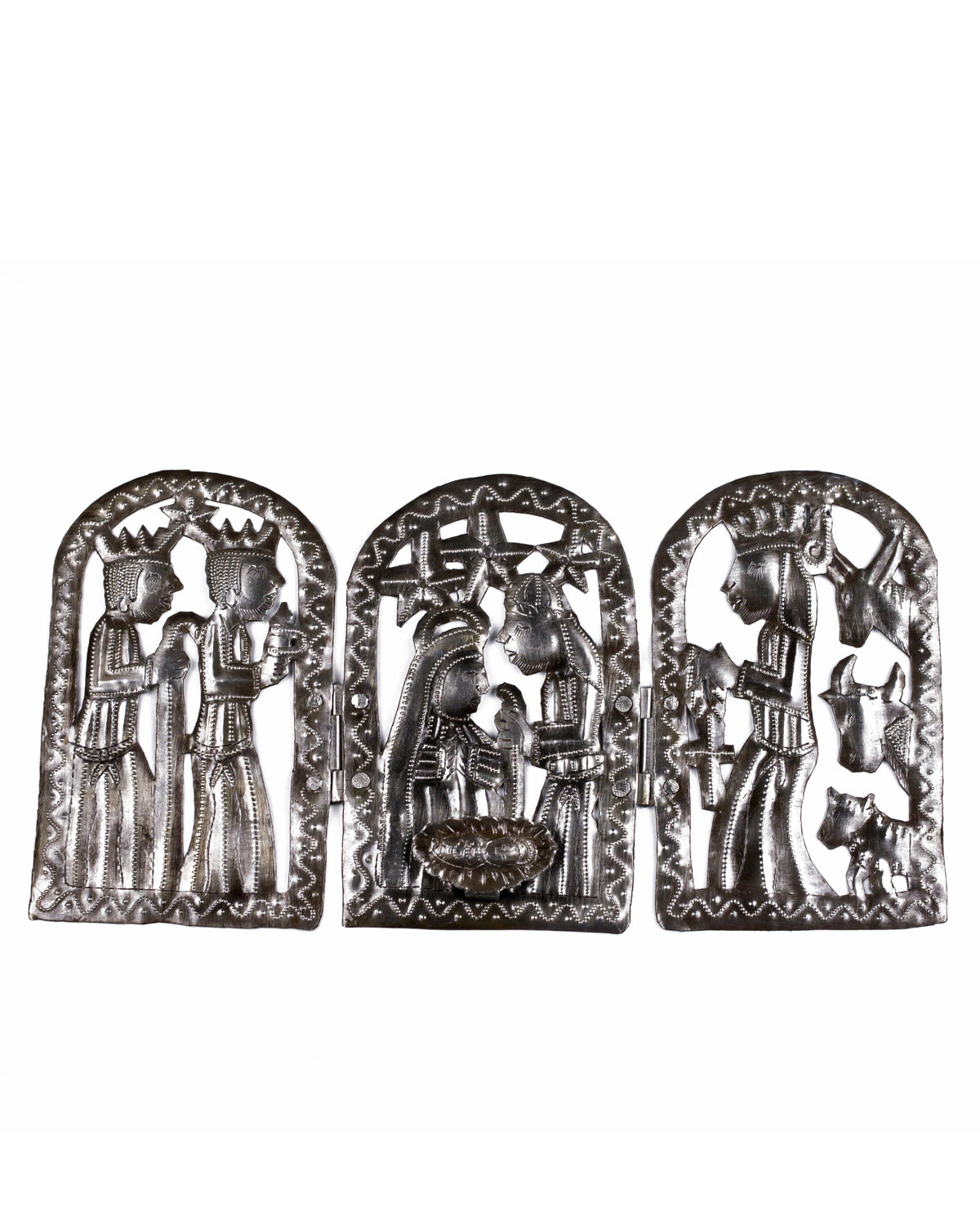 A handcrafted metal nativity set made up of three panels depicting different scenes, placed horizontally, with intricate cut-out designs.