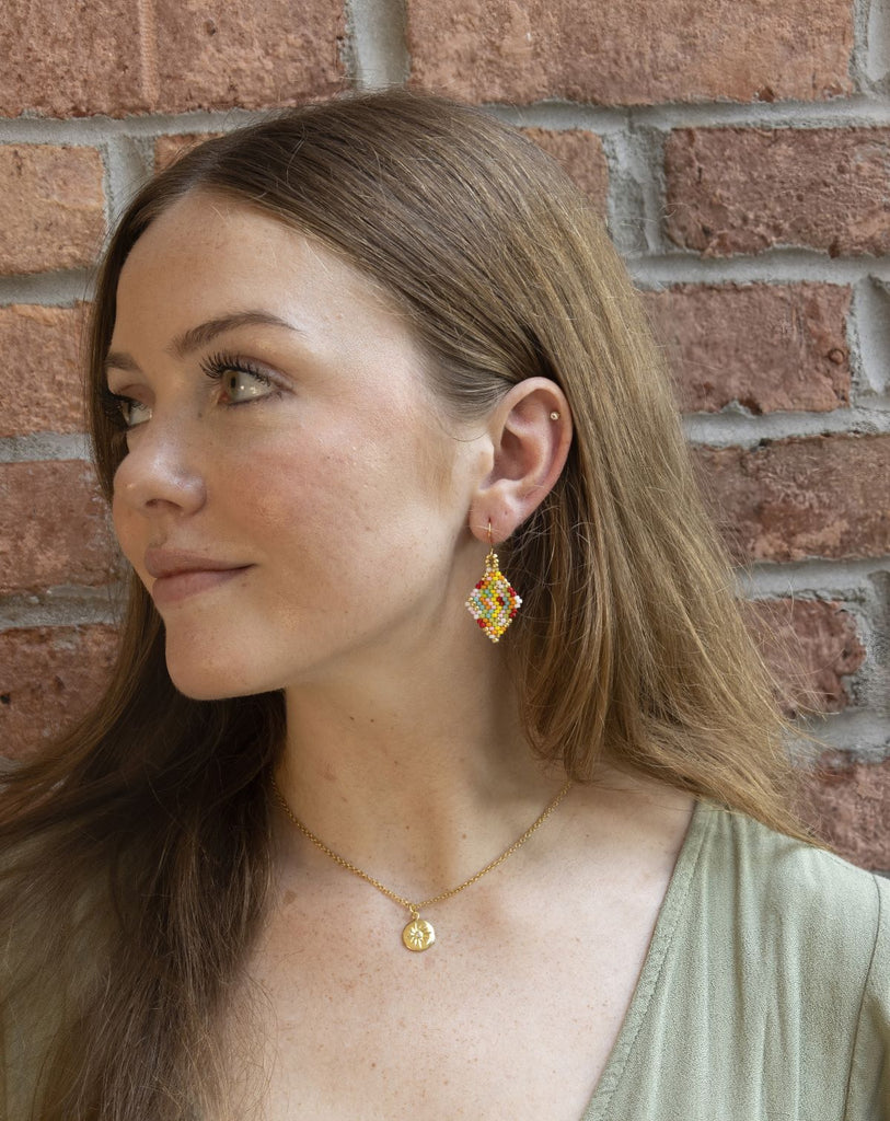 large beaded multicolor diamond-shaped earrings on model