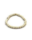 Round cream colored howlite beads with brown markings on a stretchy cord
