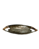 Decorative metal tray with a hammered finish on a white background