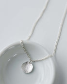 silver disc charm on 16" silver chain
