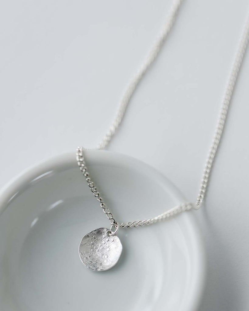 silver disc charm on 16" silver chain