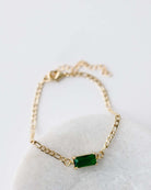 Gold figaro chain bracelet 6.5" with 2" extender.  Rectangle emerald green CZ connector.