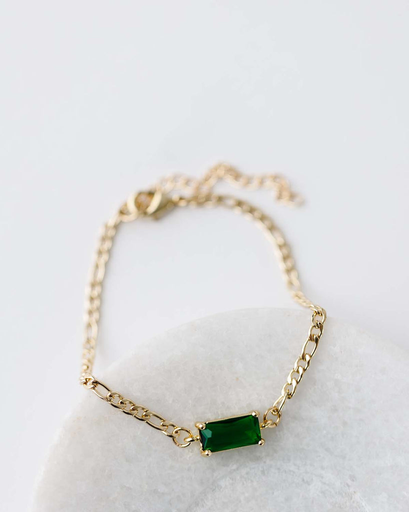 Gold figaro chain bracelet 6.5" with 2" extender.  Rectangle emerald green CZ connector.