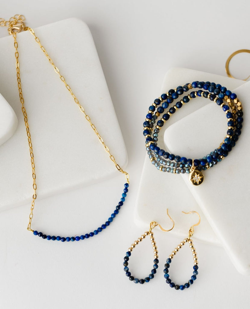collection of gold jewelry with lapis lazuli stones