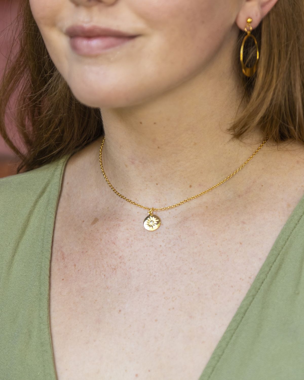 gold chain necklace with small starburst pendant