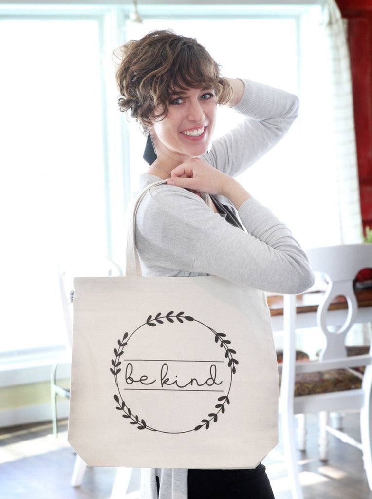 Canvas tote bag with "be kind" screen printed on the front.